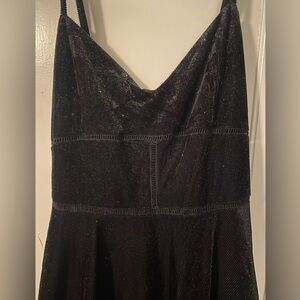 Black cocktail. Bought for homecoming- never wore. Size Large.